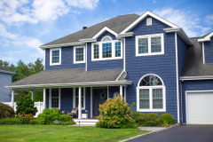 Two-story blue house with white trim and a front porch.