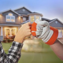 Homeowner and worker fist pounding 